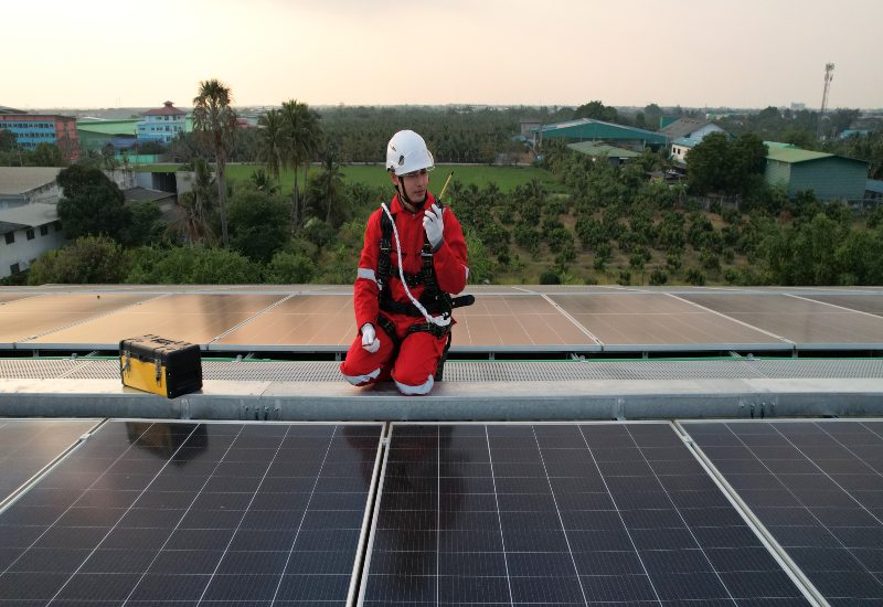 Technician Installing Black Solar Panels on the Rooftop in Ocala, FL