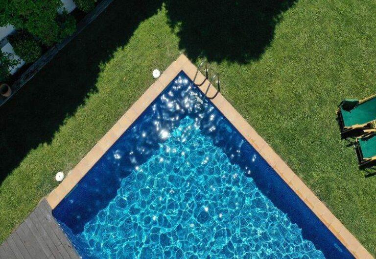 Sunlit Backyard Pool with Clear Blue Water, Ideal for Solar Heating in Colder Months in Ocala, FL